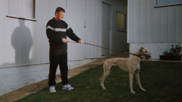 John Burrows, a local greyhound trainer, with Sandy, one of his greyhounds.
