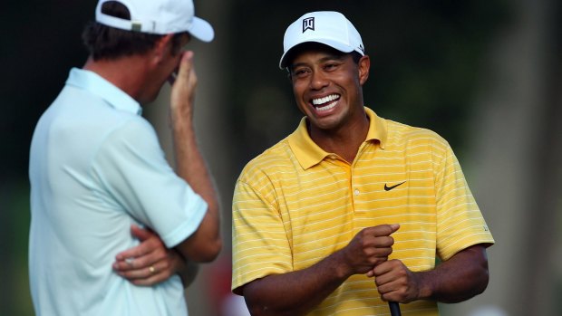 Tiger Woods laughs with Richard Green of Australia during a practice round prior to the start of the 89th PGA Championship in Tulsa, Oklahoma, 2007.