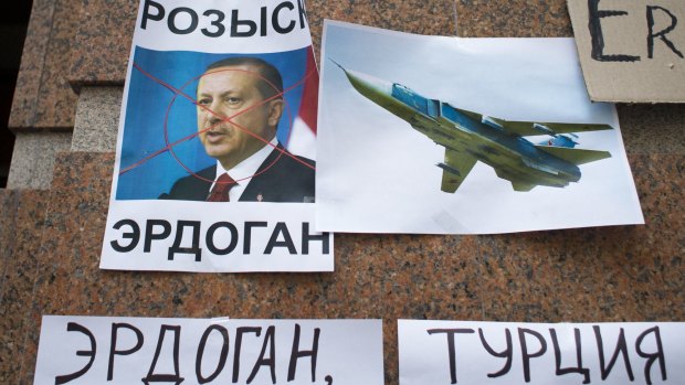 Russian anger: posters showing a portrait of Turkish President Recep Tayyip Erdogan and reading "Wanted Erdogan","Erdogan", and "Turkey", left after a protest at the Turkish embassy in Moscow.