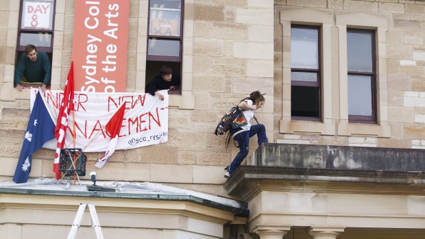 A student climbs to the administration offices of the Sydney College of Arts during a student occupation of the campus in 2016.
