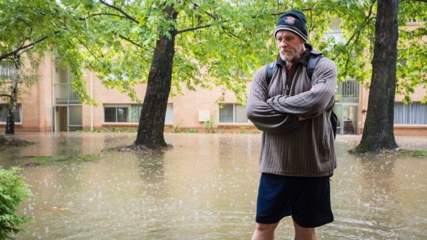 Gary Carter stands outside his flooded apartment at O'Connor. 