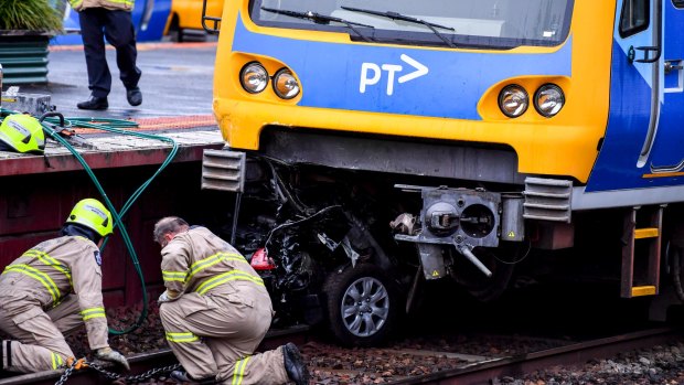 The car wedged under the train on Wednesday afternoon. 