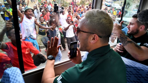 Hero worship: Jack Bird and Valentine Holmes meet the locals in Port Moresby.