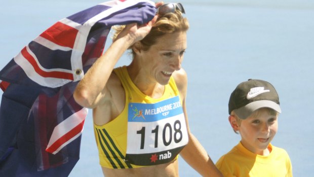 Australia's Kerryn McCann celebrates her marathon victory with son Benton.