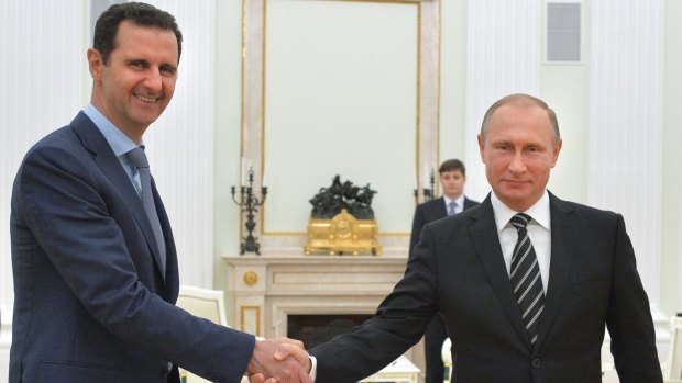 Firm ally ... Syrian President Bashar al-Assad shakes hands with Russian President Putin.