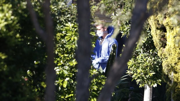 A forensic worker at the Glenfield house where a 15-year-old boy was shot in the head.