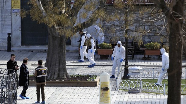 Turkish forensic police officers search for evidence at the site of the suicide bombing, in the historic Sultanahmet district of Istanbul.