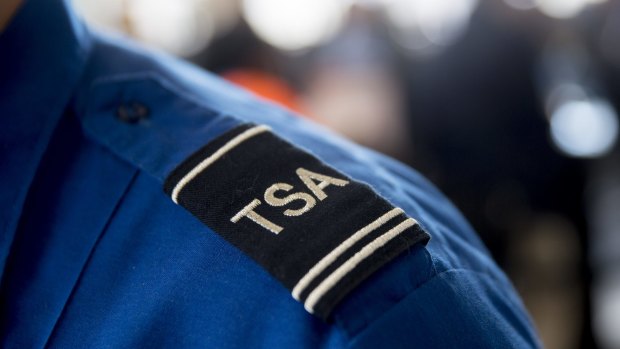 A Transportation Security Administration (TSA) officer stands for a photograph at a security checkpoint at Ronald Reagan National Airport (DCA) in Washington, DC.