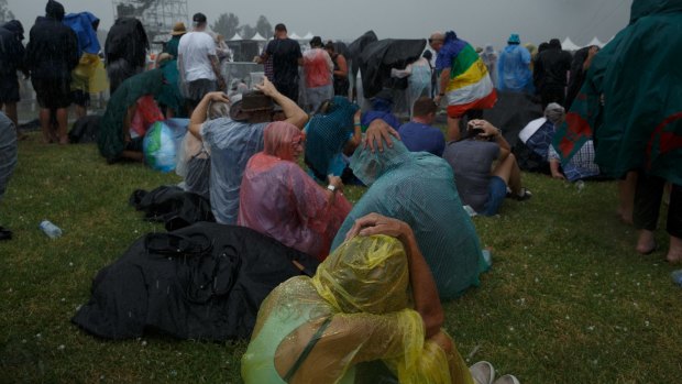 Crowds attempt to shelter from a barrage of hailstones at a Bruce Springsteen concert at Hope Estate, Pokolbin.