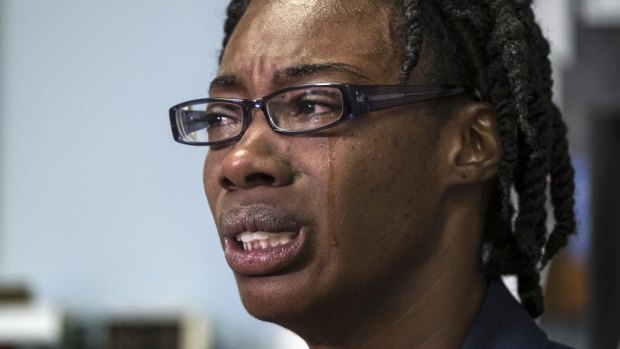Teacher Breaion King is overcome with emotion as she describes being pulled thrown to the ground by a police officer.