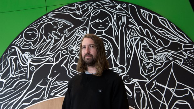 David Booth (aka Ghostpatrol) in front of one the murals he has painted for the new Pauline Gandel Children's Gallery at Melbourne Museum.
