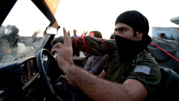 Reinforcements: A peshmerga fighter arrives at the Habur crossing along the Turkish-Iraqi border.