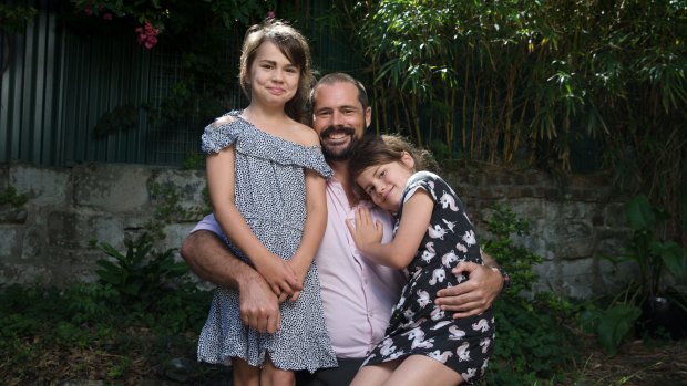 Jake Burgess with his daughters, Georgia, 9, left, who has undergone treatment for leukemia, and Alice, 5, in Sydney.