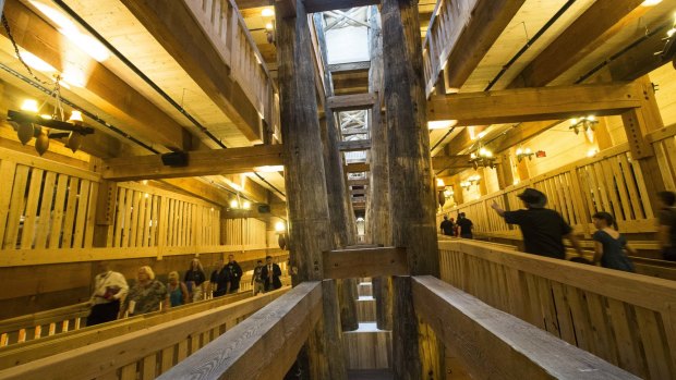 Visitors pass along the central support beams of a replica Noah's Ark.