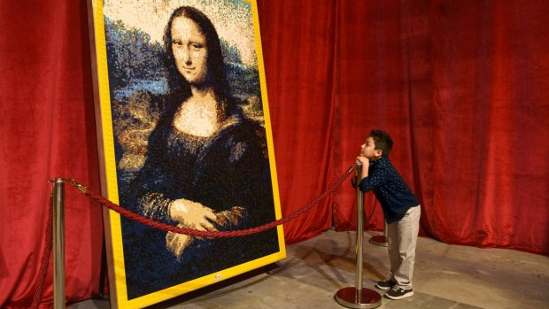 Elias Jose Raish admires a Lego construction of the <i>Mona Lisa</i>, part of an exhibition that features about 2 million of the toy bricks. 