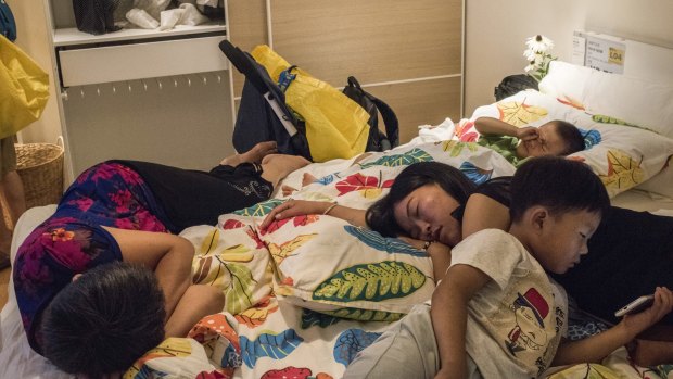 A family takes time to rest on a display bed at an IKEA store in Beijing.