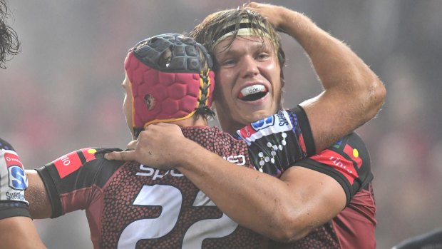 Hamish Stewart (left) of the Reds celebrates after scoring a try with teammate Adam Korczyk.