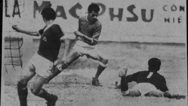 Singapore's goalkeeper (No. 1) goes down at the feet of Australian player Ray Baartz.