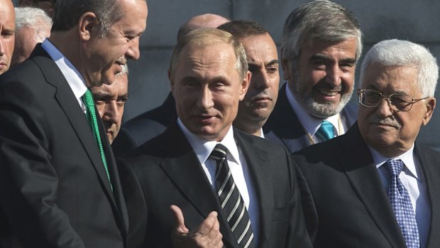 Tete-a-tete: Russian President Vladimir Putin, centre, with Turkish President Recep Tayyip Erdogan, left, and Palestinian President Mahmoud Abbas, right, at the re-opening  of the Cathedral Mosque in Moscow on Wednesday.