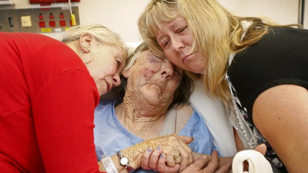 Mavis Dillon is comforted in  Sunshine Hospital after being bashed by a car thief.