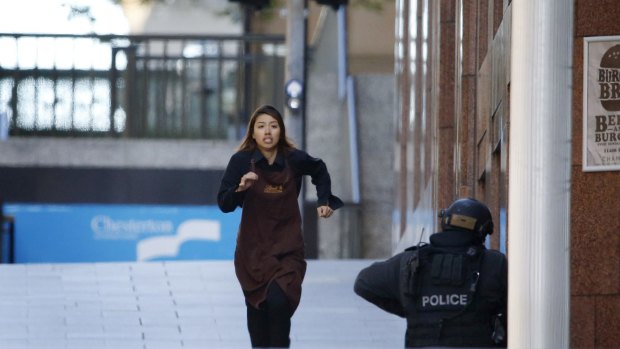A Lindt worker believed to be Elly Chen flees the cafe. 