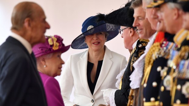 UK Prime Minister Theresa May looks on as Queen Elizabeth II and Prince Philip greet dignitaries during the state visit by King Felipe and Queen Letizia of Spain on Wednesday.