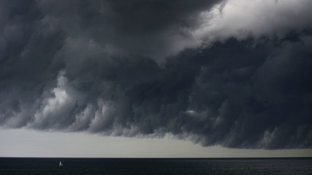A yacht is dwarfed by last week's big storm cell off Sydney.