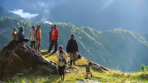  Men gather to talk in the remote highlands village of Lolat.