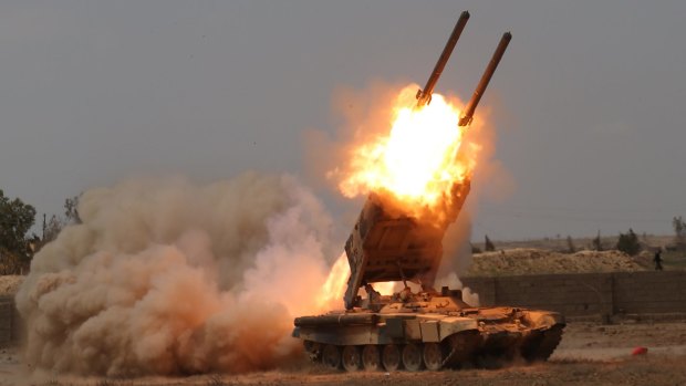 Iraqi security forces launch rockets against Islamic State extremist positions in Tikrit before taking the city.