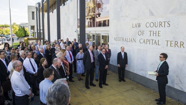 ACT Bar Association president Shane Gill, right, leads members of the legal profession in a minute's silence outside the ACT Supreme Court.