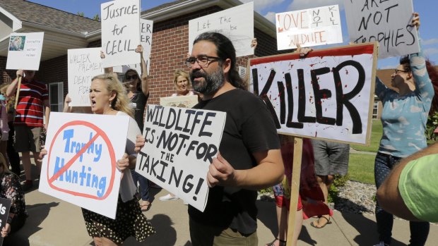 Protestors gather outside Dr Walter Palmer's dental office in Bloomington, Minnesota, in July. 