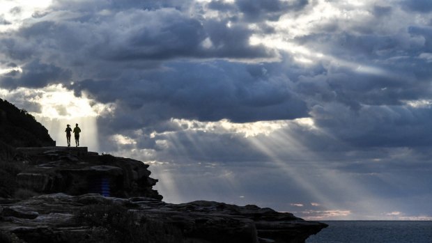Early morning walkers make their way around the Bondi to Bronte cliff path. 