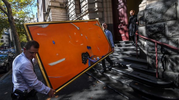 Brett Whiteley's 'Orange Lavender Bay' is carried from the court after Gant and Aman's appeal was heard.