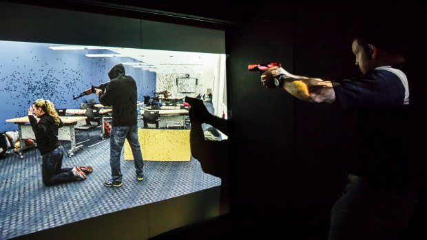 Paul Burns demonstrates the active shoot simulations authorities must navigate inside ATS' "live box" mobile shooting range.