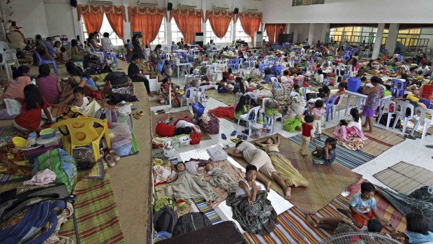 Preparing: People take shelter inside a evacuation centre in Surigao city, southern Philippines. 