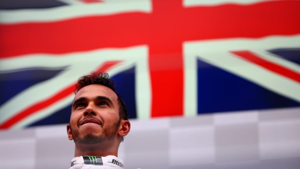 Lewis Hamilton of Great Britain and Mercedes GP looks on from the podium after winning the Formula One Grand Prix of Austria.