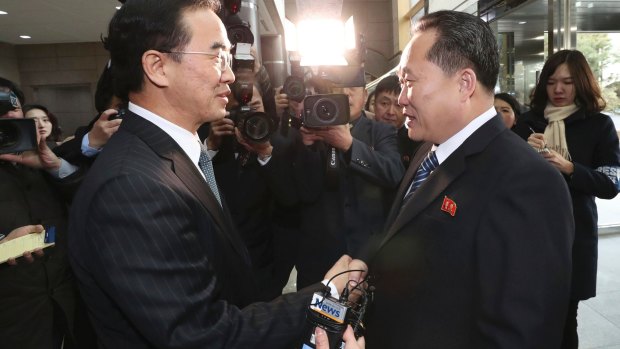 South Korean Unification Minister Cho Myoung-gyon, left, shakes hands with the head of North Korean delegation Ri Son-gwon before their meeting on Tuesday.