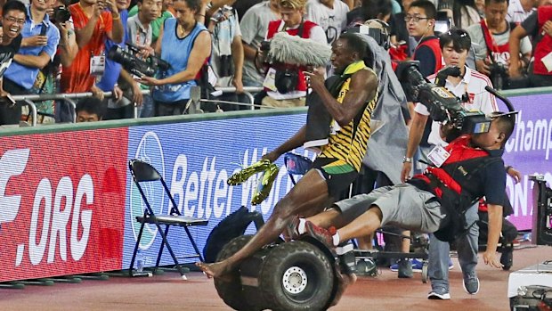 Usian Bolt is hit by a cameraman on a Segway as he celebrates winning the men's 200 metres final at the World Championships in Beijing.