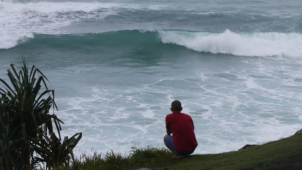 A man watches the waves at Burleigh Heads.