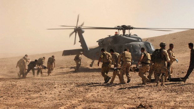 Australian and Afghan troops  evacuate civilian victims of a Taliban roadside bomb in Uruzgan Province, Afghanistan.

