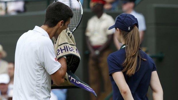 Novak Djokovic  wipes his face during his match against Kevin Anderson. 