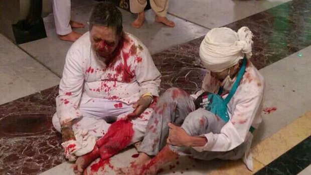 Wounded pilgrims sit on the floor after a crane collapse inside the Grand Mosque in Mecca, Saudi Arabia.