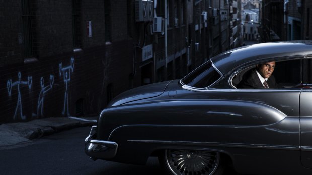 Lawyer Adam Houda takes a ride in his 1950 Chevy, one of a number of old American cars he owns.