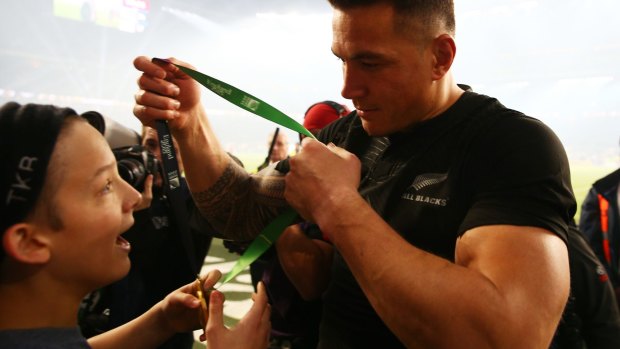 Gracious: Sonny Bill Williams gives his medal to young fan Charlie Lines.
