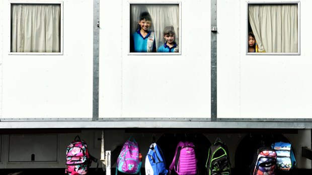 National School for travelling Show Children: Pictured is Bay Gill (10) and Ash Johnson (8) with Oliver Watkins (5) at the windows of the Show School classroom.