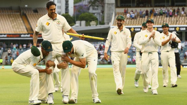 Mitchell Johnson's teammates chair him off after his retirement in Perth.