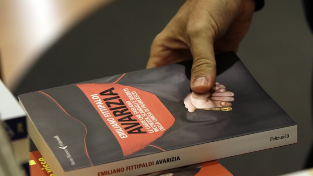 Italian journalist  Emiliano Fittipaldi holds his book "Avarice" in Rome on Tuesday. 
