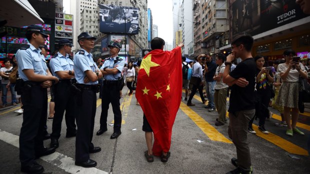 Tensions: a pro-Beijing protester takes police to task in Hong Kong.
