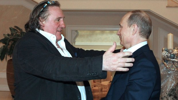 French actor Gerard Depardieu, left, greets Russian President Vladimir Putin at the President's residence in Sochi in 2013.