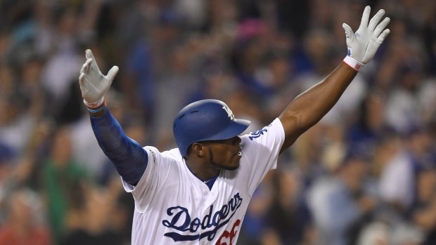 Runs on the board: Los Angeles Dodgers' Yasiel Puig celebrates after hitting an RBI double.